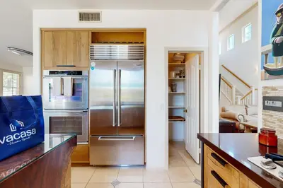 a kitchen with a stainless steel refrigerator at Torrey Treats House in San Diego