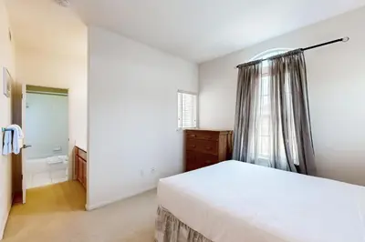 a white bedroom with a bed and a window at Torrey Treats House in San Diego