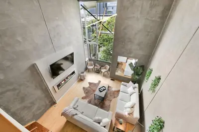 an overhead view of a living room with a fireplace at New York Style Penthouse in the heart of the city in San Diego