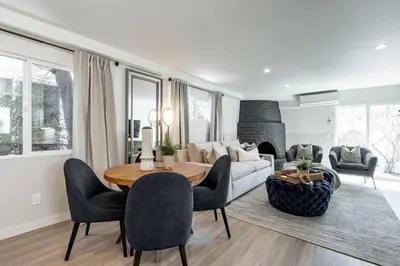 a living room with a couch and a table and chairs at The Rosemont - La Jolla Luxury in San Diego