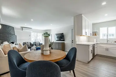 a kitchen and a living room with a table and chairs at The Rosemont - La Jolla Luxury in San Diego
