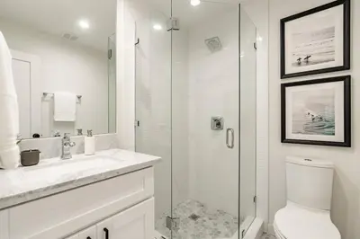 a white bathroom with a shower and a toilet at The Rosemont - La Jolla Luxury in San Diego