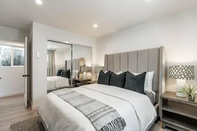 a white bedroom with a large bed and a mirror at The Rosemont - La Jolla Luxury in San Diego