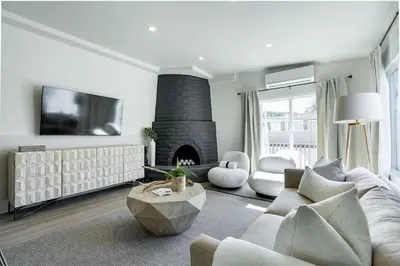 a living room with a couch and a fireplace at The Rosemont II - La Jolla Luxury in San Diego