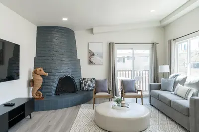 a living room with a couch and a fireplace at The Rosemont IV - La Jolla Luxury in San Diego