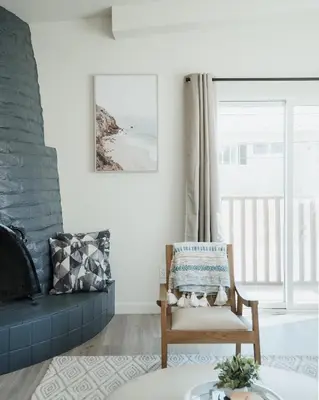 a living room with a chair and a fireplace at The Rosemont IV - La Jolla Luxury in San Diego