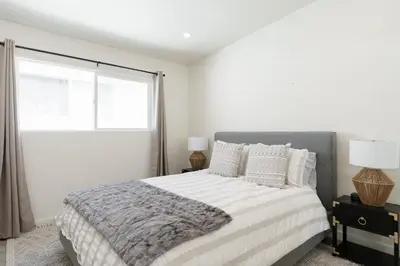 a white bedroom with a bed and a window at The Rosemont IV - La Jolla Luxury in San Diego