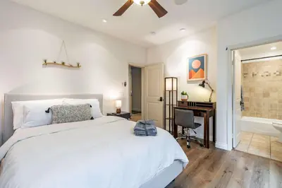 a bedroom with a bed and a desk and a tub at The San Diego Studio - Free Parking in San Diego