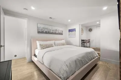 a white bedroom with a large bed and a table at The California II - Mission Hills Hideaway in San Diego