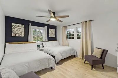 a bedroom with two beds and a ceiling fan at The California III in San Diego