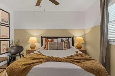 a bedroom with a bed with pillows and two lamps at No bad days in San Diego in San Diego