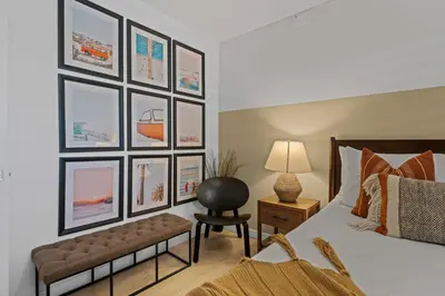 a bedroom with a bed and a chair and pictures on the wall at No bad days in San Diego in San Diego