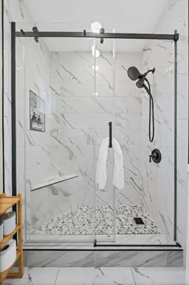 a shower in a bathroom with white marble at Live like a local - Studio with huge backyard in San Diego