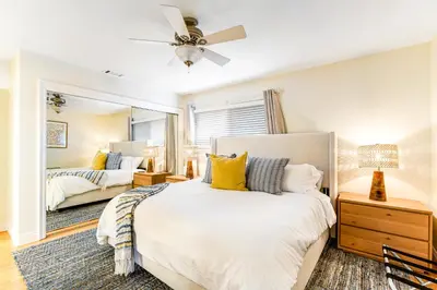 a bedroom with a bed and a mirror at Canyon Cove Oceanside in Oceanside