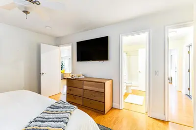 a bedroom with a bed and a tv on a wall at Canyon Cove Oceanside in Oceanside