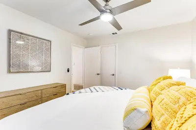 a bedroom with a bed and a ceiling fan at Canyon Cove Oceanside in Oceanside