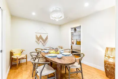 a dining room with a wooden table and chairs at Canyon Cove Oceanside in Oceanside