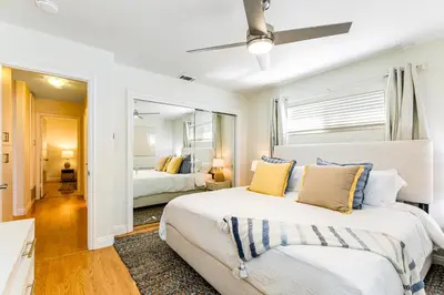 a bedroom with two beds and a mirror at Canyon Cove Oceanside in Oceanside