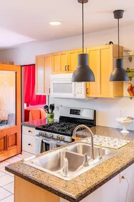 a kitchen with a sink and a stove at Serenity House near Gaslamp, San Diego Zoo & Petco in San Diego
