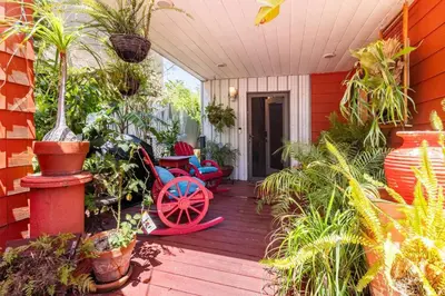 a porch with plants and a red house at Serenity House near Gaslamp, San Diego Zoo & Petco in San Diego