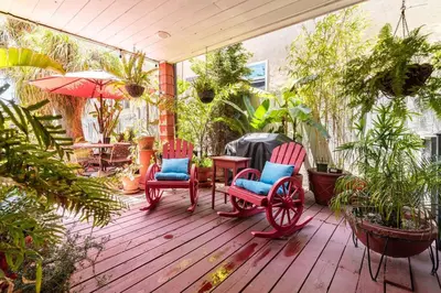 a patio with two red chairs and a table at Serenity House near Gaslamp, San Diego Zoo & Petco in San Diego