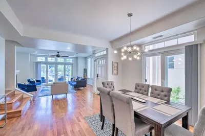a dining room and living room with a table and chairs at Oceanside Home with Rooftop Patio - Steps to Beach! in Oceanside