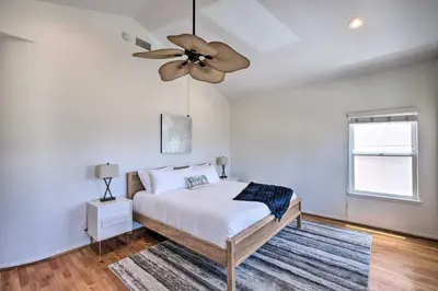 a bedroom with a bed and a ceiling fan at Oceanside Home with Rooftop Patio - Steps to Beach! in Oceanside
