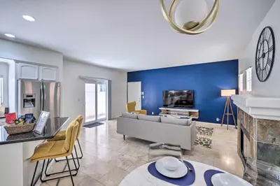 a living room with a couch and a fireplace at Oceanside Home with Rooftop Patio - Steps to Beach! in Oceanside