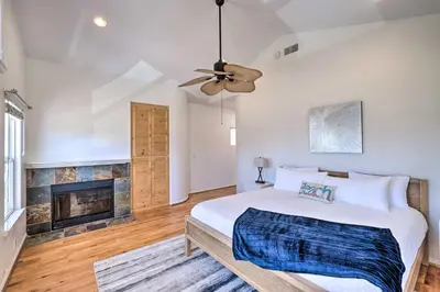 a bedroom with a bed and a fireplace at Oceanside Home with Rooftop Patio - Steps to Beach! in Oceanside