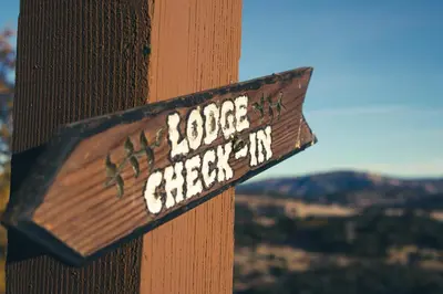 a sign that says ropeaggression on a wooden pole at Tucker Peak Lodge in Julian