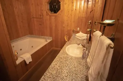 a bathroom with a sink and a tub and a toilet at Tucker Peak Lodge in Julian
