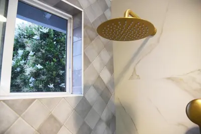 a bathroom with a window and a shower at Mile to Beach! Fully Fenced Private SoCal Cottage in Oceanside