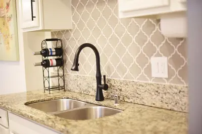a kitchen sink with a faucet on a counter at Mile to Beach! Fully Fenced Private SoCal Cottage in Oceanside