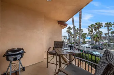 a balcony with a grill and a table and chairs at Buccaneer Beach Lookout - 30-Night Minimum in Oceanside
