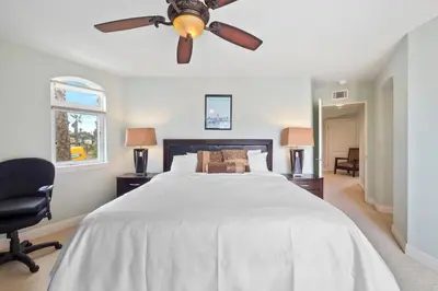 a bedroom with a bed with a ceiling fan at Buccaneer Beach Lookout - 30-Night Minimum in Oceanside