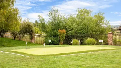 a tennis court with two golf greens on it at Secluded Estate Exclusive Views of Wine Country Private Home Theater Twilight Vines by AvantStay in Sage