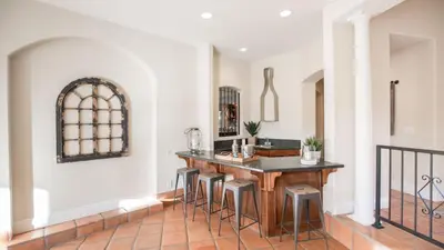 a dining room with a table and stools at Grapevine by AvantStay Secluded 5BR Villa 4 Acres of Vineyards Avo Groves in Temecula
