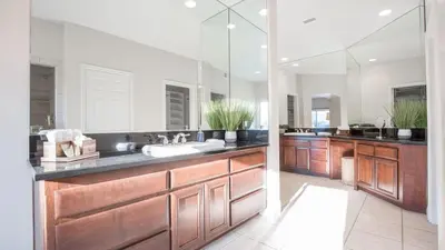 a bathroom with two sinks and a large mirror at Grapevine by AvantStay Secluded 5BR Villa 4 Acres of Vineyards Avo Groves in Temecula