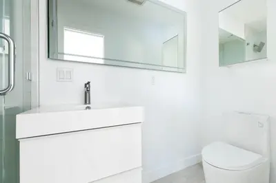 a white bathroom with a sink and a toilet at Avalon 2 Unit Buyout II IV by AvantStay Mins to Gaslamp Patio w BQQ in San Diego