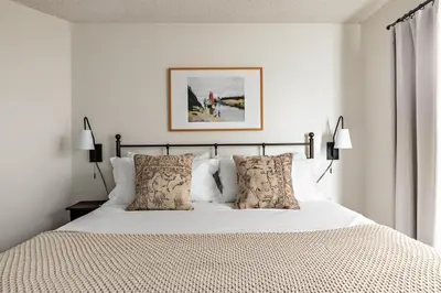 a bedroom with a white bed with pillows at Bay View 3 by AvantStay Stunning Home on the Beach In Mission Beach in San Diego