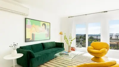 a living room with a green couch and a yellow chair at Avalon Buyout by AvantStay Mins to Gaslamp Rooftop w BBQ Patio in San Diego