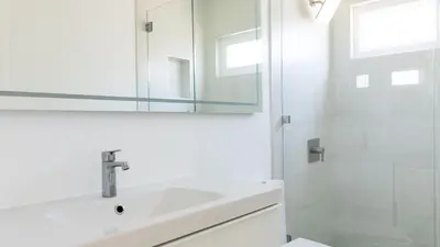 a white bathroom with a sink and a shower at Avalon 2 Unit Buyout I III AvantStay Mins to GaslampBeautiful Deck w BBQ in San Diego