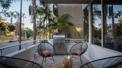 a balcony with two chairs and a stove at Balboa Buyout by AvantStay - Condo w Views in DT San Diego in San Diego