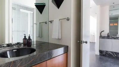 a bathroom with a sink and a mirror at Balboa Buyout by AvantStay - Condo w Views in DT San Diego in San Diego