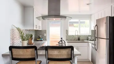 a kitchen with a refrigerator and two chairs in it at Hamilton II by AvantStay Beach House Rooftop Deck Newly Renovated Bungalow in San Diego