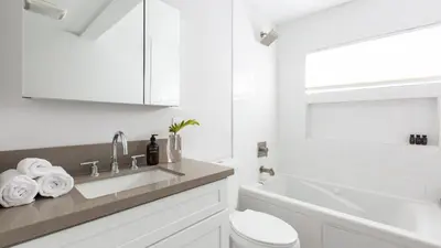 a white bathroom with a sink and a toilet at Hamilton II by AvantStay Beach House Rooftop Deck Newly Renovated Bungalow in San Diego
