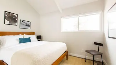 a bedroom with a large bed and a window at Hamilton II by AvantStay Beach House Rooftop Deck Newly Renovated Bungalow in San Diego