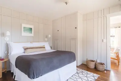 a white bedroom with a large bed in it at Topaz By AvantStay Adorable Cottage Walking Distance to Beach w Large Patio in San Diego