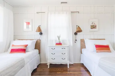 two beds in a bedroom with white walls at Topaz By AvantStay Adorable Cottage Walking Distance to Beach w Large Patio in San Diego