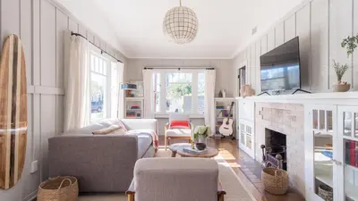a living room with a couch and a fireplace at Topaz By AvantStay Adorable Cottage Walking Distance to Beach w Large Patio in San Diego